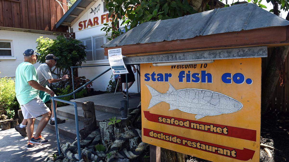 Customers arrive at Star Fish Co. Restaurant as a crew from "Emeril's Florida," a cooking show featuring chef and restaurateur Emeril Lagasse, films in Cortez for a segment for the show. 
 TIFFANY TOMPKINS-CONDIE/Bradenton Herald