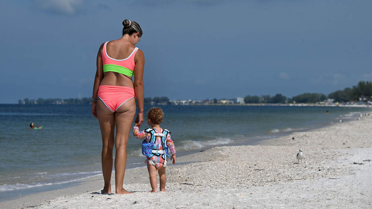 Lisa Pantalone and Novah, 18 mos., stroll the waterside on a visit from Michigan.