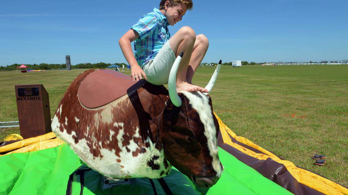 Ethan Shortridge, 12, laughingly describes an earlier ride on the mechanical bull at the Premier Sports Campus in Lakewood Ranch where there My Hometown Fest will be held from noon-6 p.m. Saturday.TIFFANY TOMPKINS/Bradenton Herald