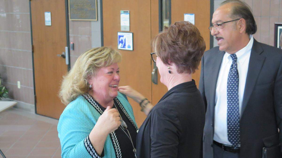 Cheri Coryea (left) hugs Manatee County staff members moments after she was officially appointed to serve as acting county administrator following Ed Hunzeker’s retirement on Friday.