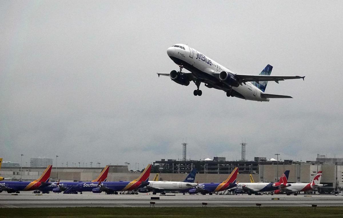 A line of grounded airliners is seen Tuesday, Dec. 27, 2022, at Fort Lauderdale-Hollywood International Airport. A brutal winter storm has caused major delays in air travel across the U.S.
