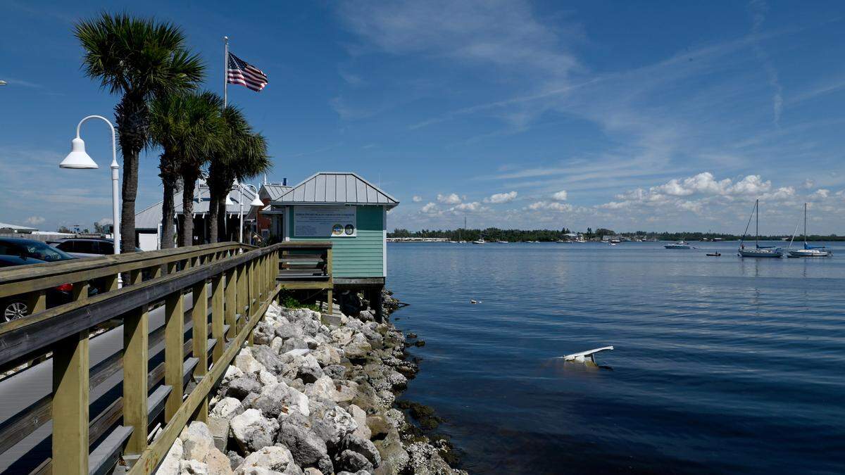 After Hurricane Ian, some aluminum debris sits in the water to the right of the Bridge Street Pier where people were enjoying the weather on October 3, 2022.