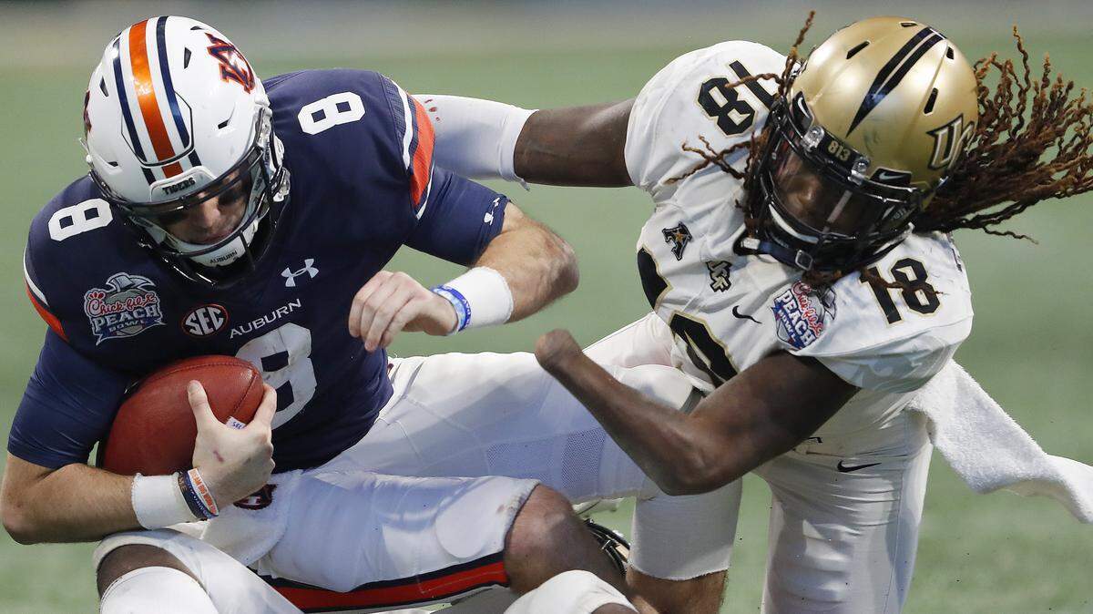 In this file photo, Central Florida linebacker Shaquem Griffin (18) sacks Auburn quarterback Jarrett Stidham (8) during the second half of the Peach Bowl NCAA college football game, Monday, Jan. 1, 2018, in Atlanta.