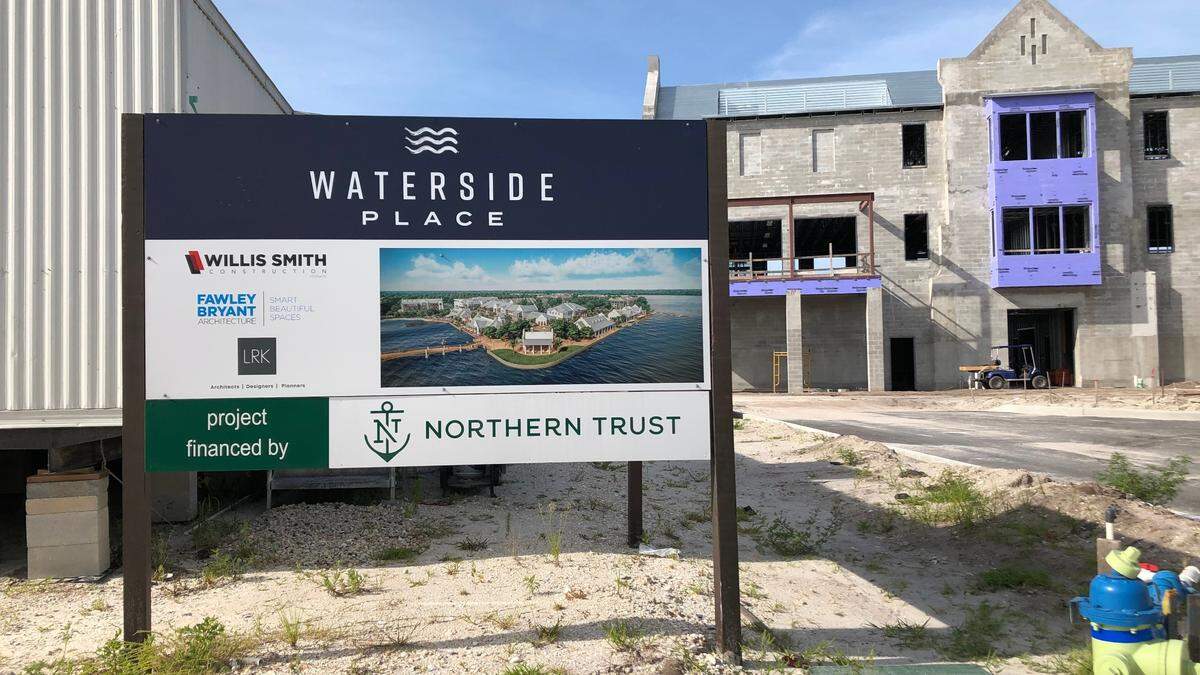 Sign outside the Willis Smith construction trailer contains an artist’s conception of what Waterside Place will look like when completed.