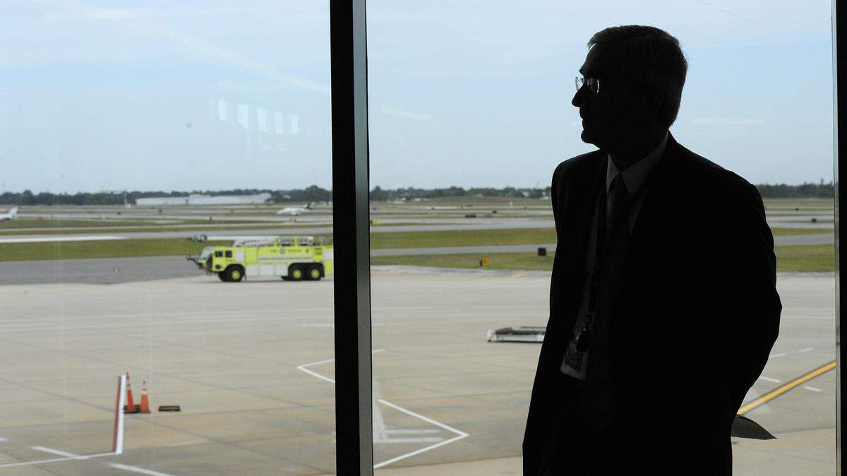 Sarasota Manatee Airport Authority president Fredrick Piccolo is outlined against the brightness of the tarmac through the windows of Gate B12 at the Sarasota Bradenton International Airport. 
 FILE ART 
 TIFFANY TOMPKINS-CONDIE/Bradenton Herald