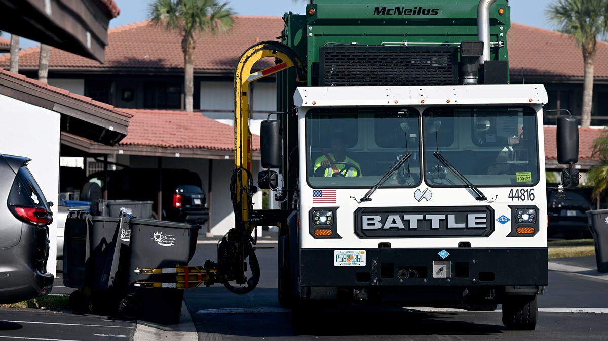 A Waste Pro truck empties trash bins in Valencia Condominiums in Bradenton on Nov. 24, 2025.