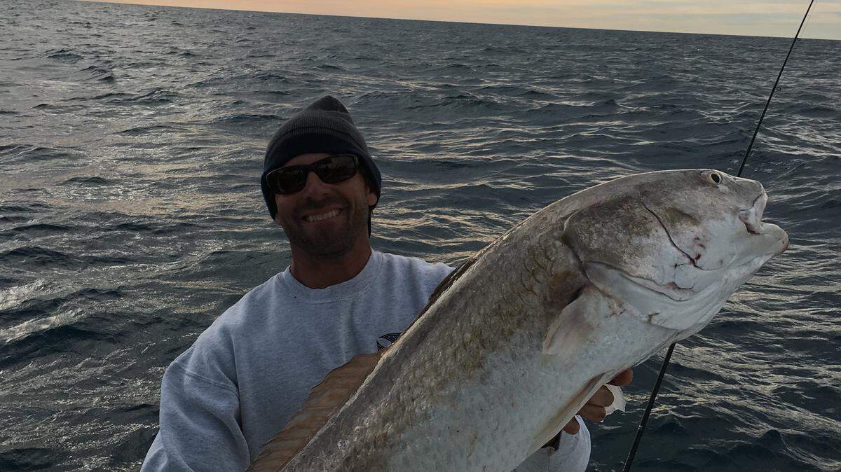Tony Destefano holds a 52-inch redfish he landed while fishing 30 miles offshore Thursday. PROVIDED PHOTO