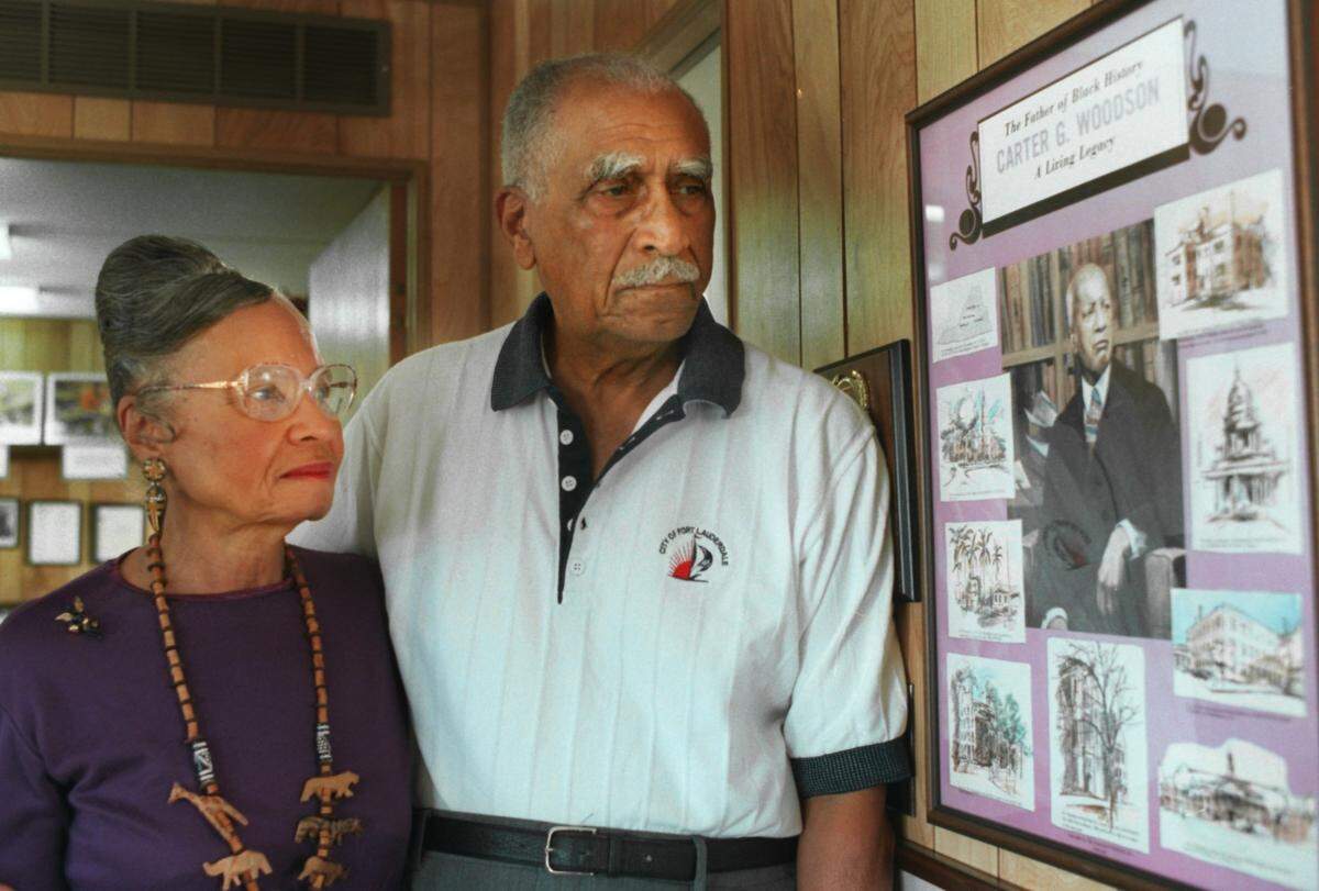 1/20/1999--Fredi and Ernest Brown, beside a picture of Carter G. Woodson, the founder of Black History, they have on display at the Family Heritage House Museum, an African American history museum.