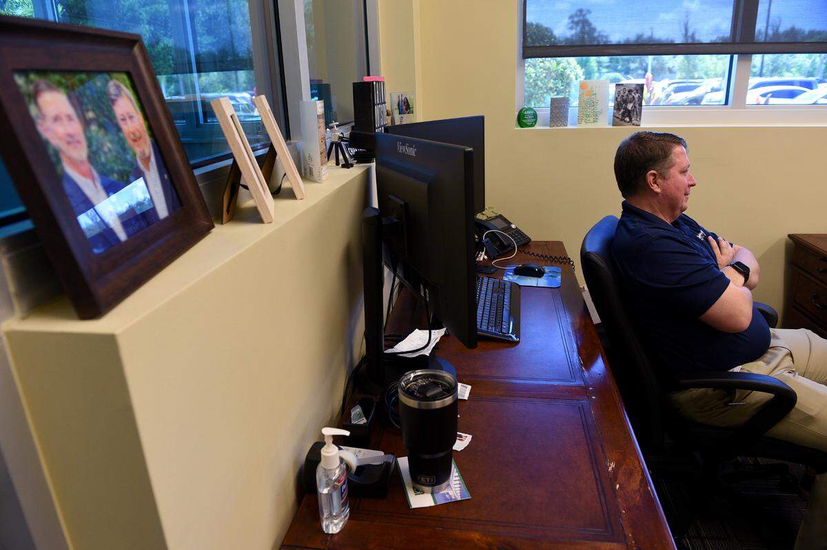 Donn Gathers watches as his mentor, Bob Rosinsky, is interviewed in the corporate offices at Manasota Goodwill.
