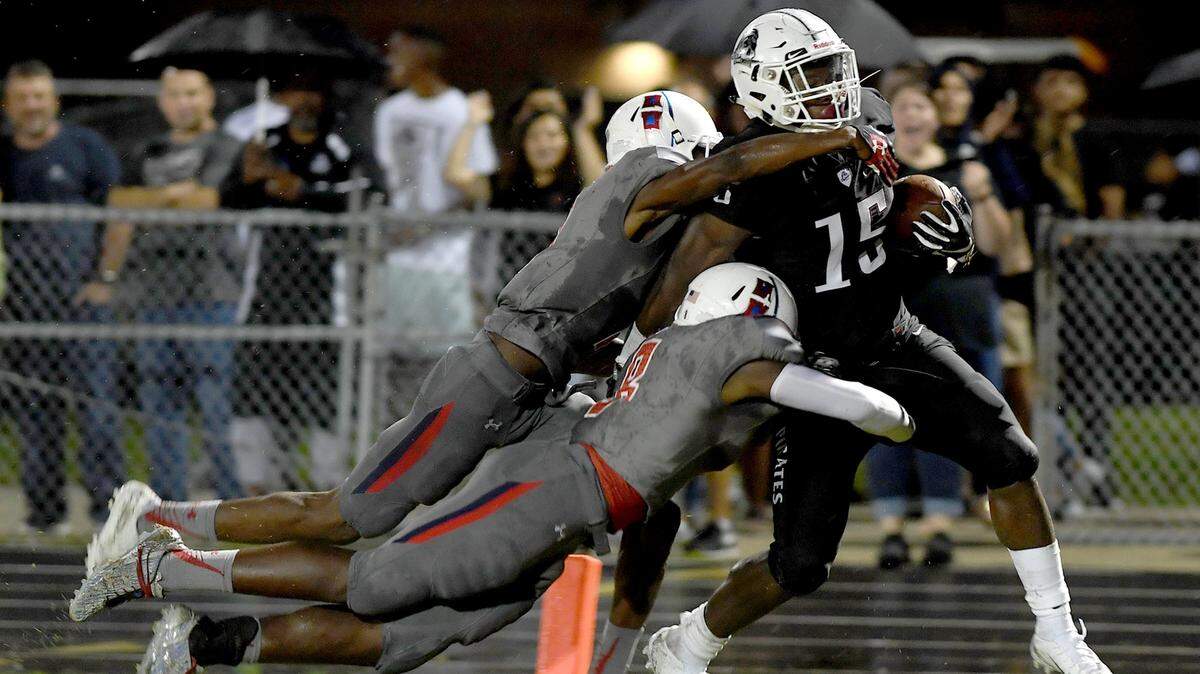 Braden River’s Knowledge McDaniel carries two Manatee players into the end zone as he scores during the Sept. 7 game at Braden River.