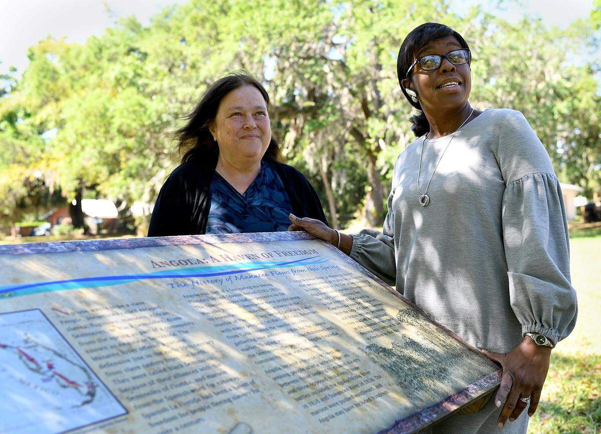 Trudy Williams of Reflections of Manatee stands with Daphney Towns, organizer of the Back to Angola Festival at Mineral Springs Park, which has revealed itself to be the location of New Angola, a settlement of escaped slaves who were driven out in 1821, escaping to the Bahamas. The pair will host the Back to Angola Festival from July 13-15.