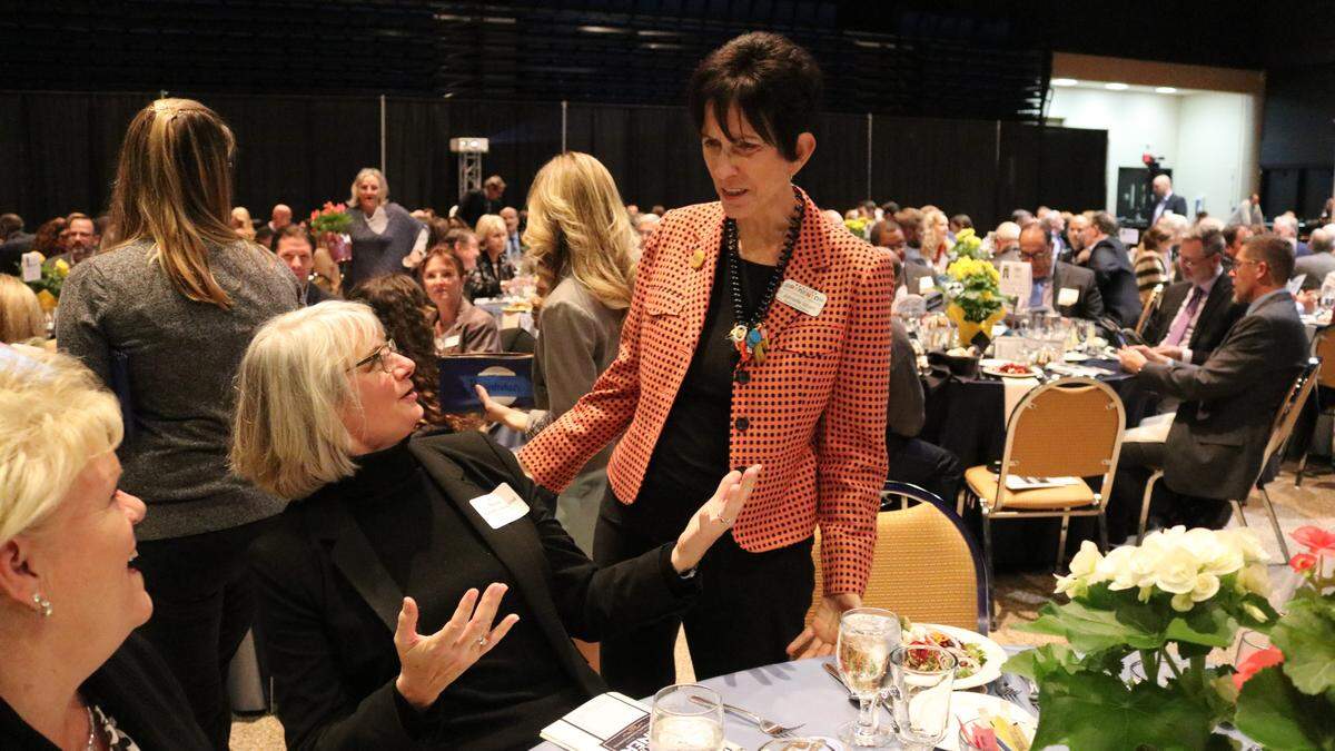 A crowd of about 550 attended the Manatee Chamber of Commerce’s annual dinner on Wednesday. Among them, Realize Bradenton’s Jonette Isham, right, shown greeting Bronwyn Beightol, Manatee Area president of the United Way.