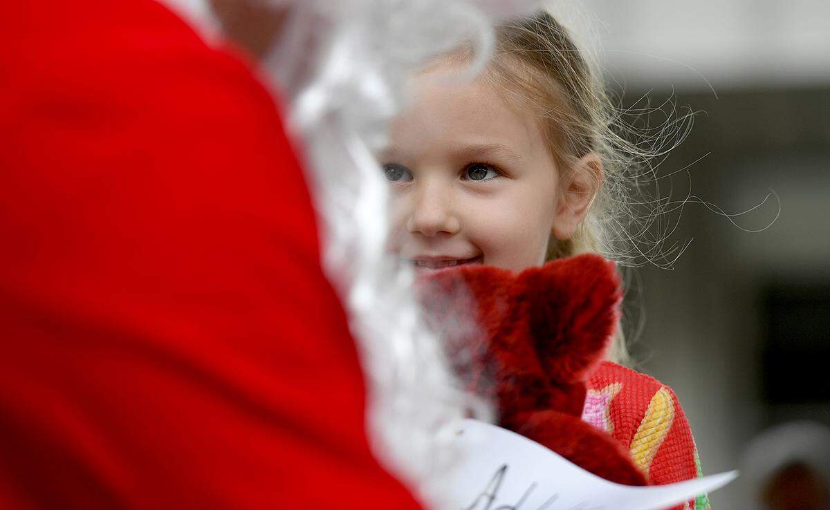 12/20/21—Addalee Reed smiles at Santa, who arrived on an East Manatee Fire Rescue truck to visit with pre-kindergarteners and ESE students at Bashaw Elementary School.