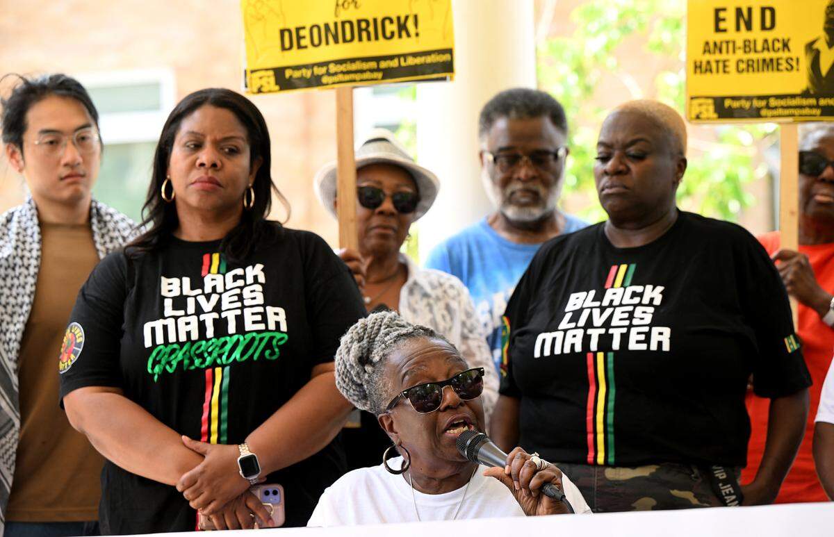 Angela Anderson, seated, speaks at a press conference held outside the Manatee County Judicial Center on Monday, June 9, 2025. Anderson’s family and supporters called on prosecutors to appeal the ruling which dismissed the case against the man who shot her son outside an Oneco bar.