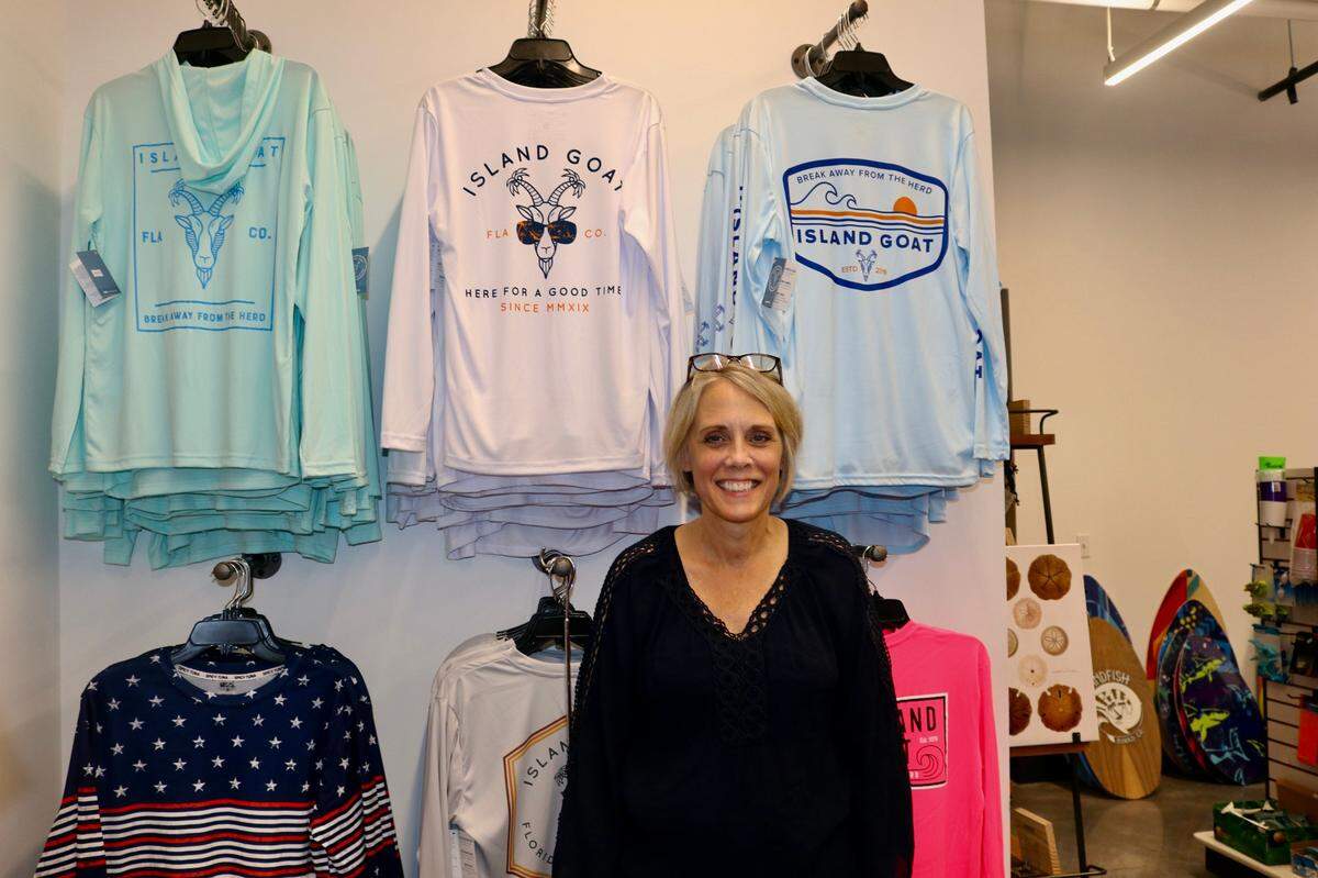 Sharon Hanzlik, shown 7/8/2022, offers a wide selection of beach merchandise at The Beach Shop which recently opened in City Centre building on Bradenton’s Old Main Street.