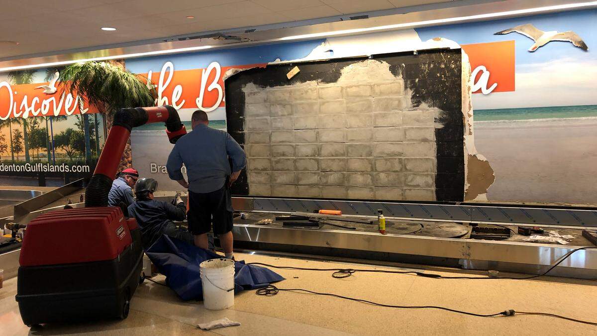 Workers were making repairs Thursday to the baggage conveyor belt that was damaged when a truck crashed at high speed through the cinderblock wall of the terminal at Sarasota Bradenton International Airport a week ago. The wall has since been repaired.