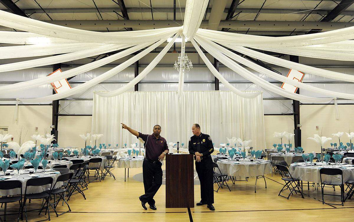 13 Av Center president Patrick Carnegie and Bradenton Police Chief Michael Radzilowski stand against the backdrop of festive wedding decorations at the 13th Av Dream Center Friday night where law enforcement officials and community leaders joined with the staff of the center to give an update on the investigation into the homicide of Brenton Coleman Sr. Grief counselors were also made available to families who needed assistance and assurances were made that security would be present for upcoming football practices.