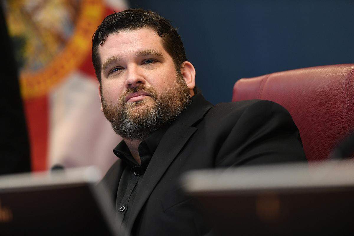 The Manatee County Commission voted unanimously to adopt a new policy allowing county employees to carry firearms at work. County Commissioner James Satcher, pictured during a 2021 meeting, proposed the idea in May 2022.