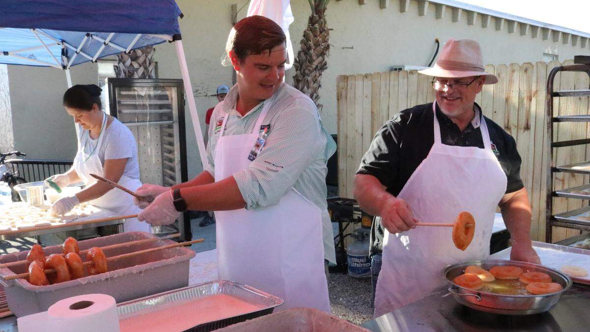 Henry Detwiler Sr., right, and his son, Sam, cook doughnuts to celebrate the opening of the original Detwiler’s Farm Market 10 years ago at 6000 Palmer Blvd., Sarasota.