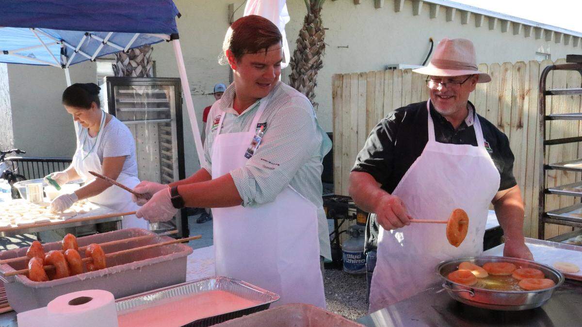 Henry Detwiler Sr., right, and his son, Sam, cooked doughnuts in 2019 to celebrate the 10th anniversary of opening of the original Detwiler’s Farm Market at 6000 Palmer Blvd., Sarasota.
