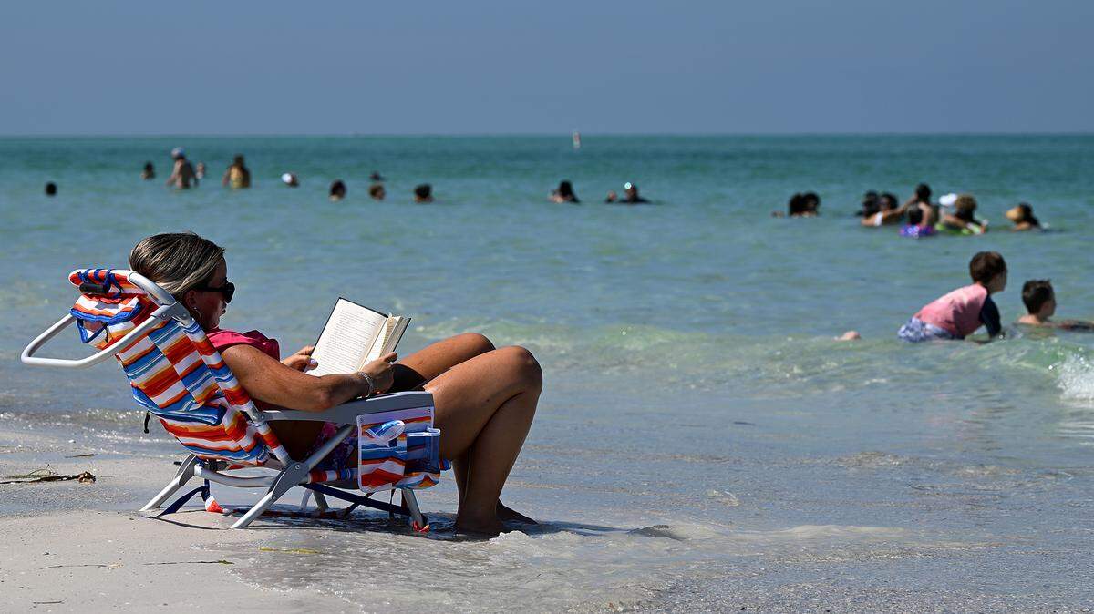 A book, a chair, and the sound of people enjoying the beach at Coquina on Monday, July 3, 2023.