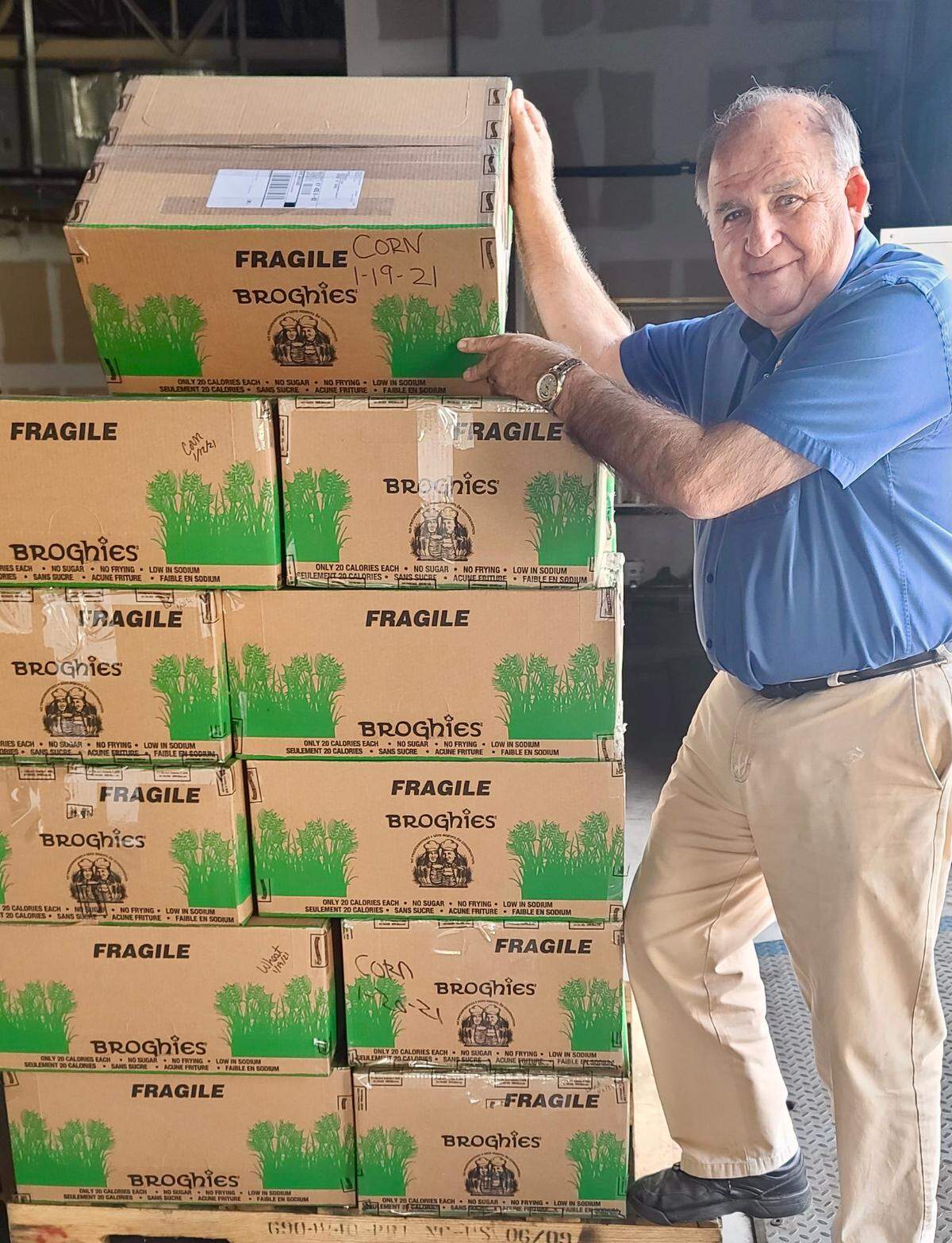 Dean Mixon stands next to boxes of Broghies ready to be shipped from Mixon’s Fruit Farms.