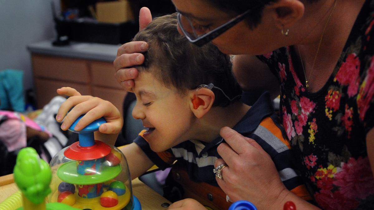 Sherri Laverty, a one-to-one paraprofessional, works with special needs student Andoni Rezola, 8, during class at Orange Ridge-Bullock Elementary. District officials are proposing to move the entire Bullock program to Rogers Garden Elementary School as a part of redistricting. GRANT JEFFERIES/Bradenton Herald