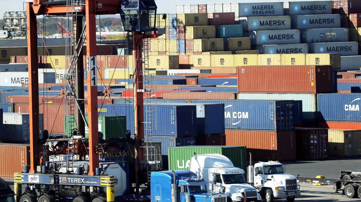 FILE- In this Friday, Oct. 30, 2015 file photograph, a straddle carrier loads a container onto a truck at the Port Newark Container Terminal in Newark, N.J. On Friday, Jan. 29, 2016, more than 1,000 longshoremen walked off the job at ports in New York and New Jersey, putting ship unloading at a standstill. The walkoff began at about 11 a.m. Friday. It wasn't immediately known what prompted the action. No ships were being unloaded and no trucks were being allowed to enter the port. (AP Photo/Julio Cortez,file)
