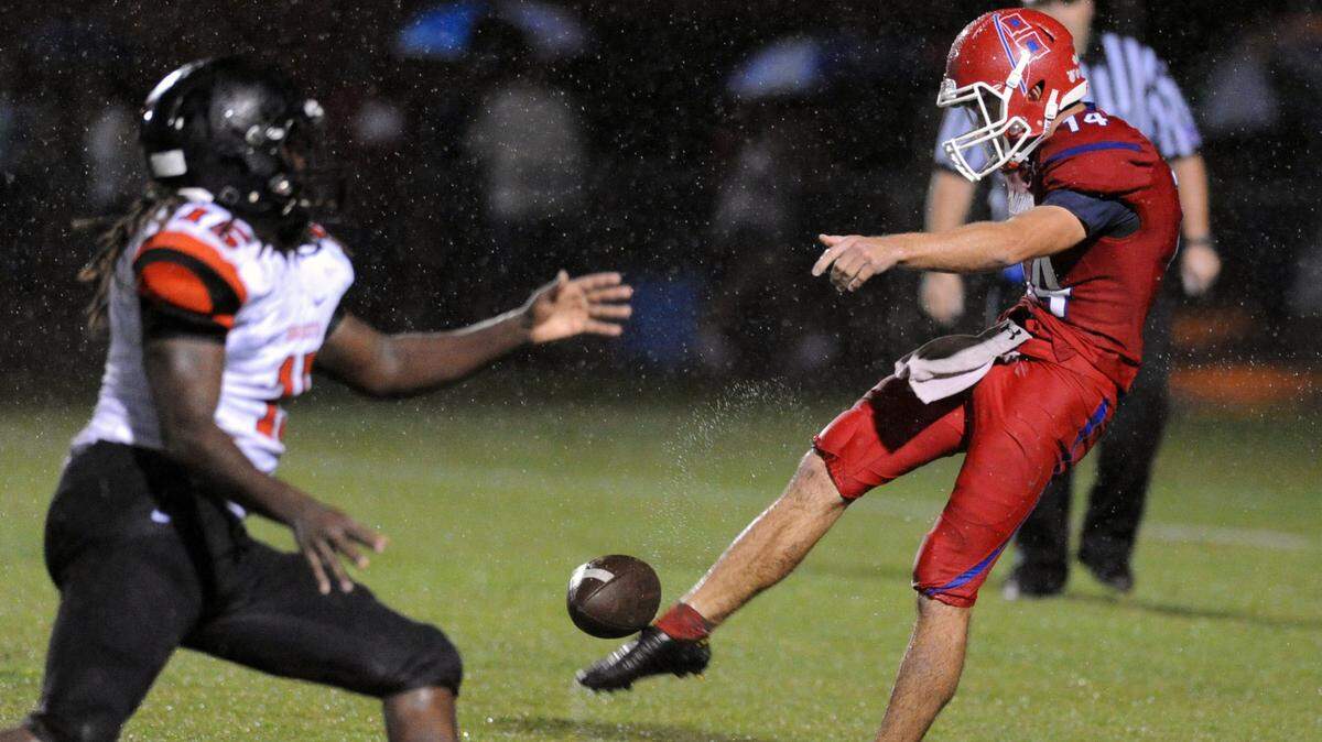 Manatee High punter Nickolas Null gets the ball away during Friday's game against Sarasota at Joe Kinnan Field at Hawkins Stadium. 
 TOM HUBBARD/Special to the Herald