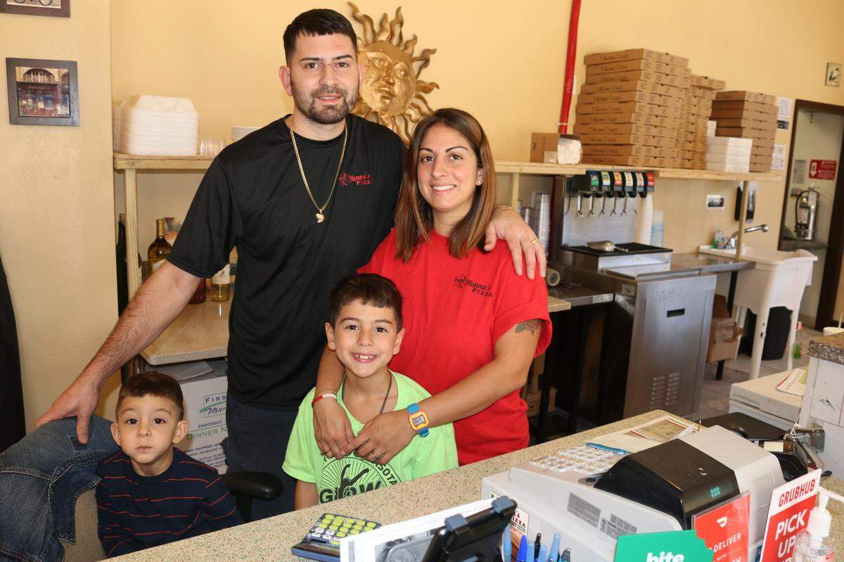 Enrique and Erina Gonzalez are shown with their sons, Giuseppe, 3, and Enrique, 7. The couple own and operate Nonna’s Pizza Restaurant.
