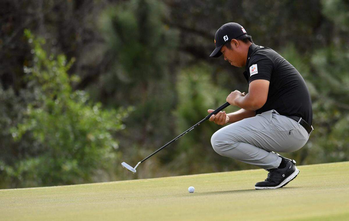 Byeong Hun An of Seoul, Korea, studies his putt on the green of the par 4, 491-yard, second hole on Friday, Feb. 18, 2022 during the second round of the LECOM Suncoast Classic  on the Korn Ferry Tour at Lakewood National Golf Club.Lecom Round 2 024
