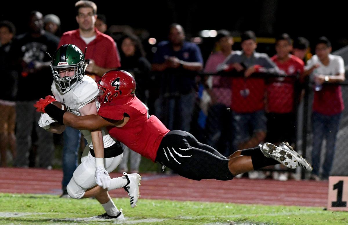 Venice’s Brandon Gregory holds tight as Palmetto’s Sagel Hickson tries to take him down at the Palmetto vs. Venice game at Palmetto Friday night.