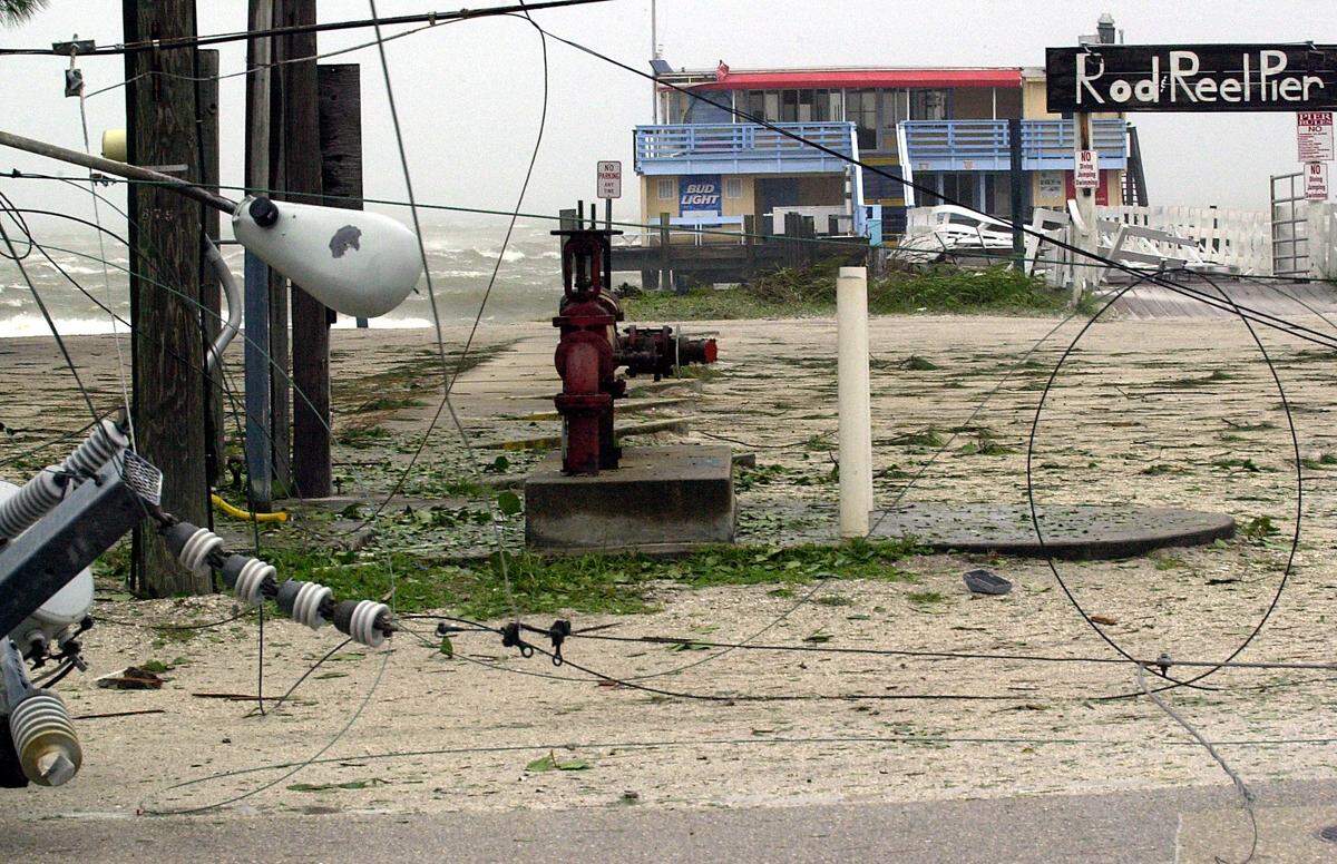A downed transformer lays in the roadway, wires blocking access to the Rod and Reel Pier which sustained some damage from Hurricane Frances in September 2004.