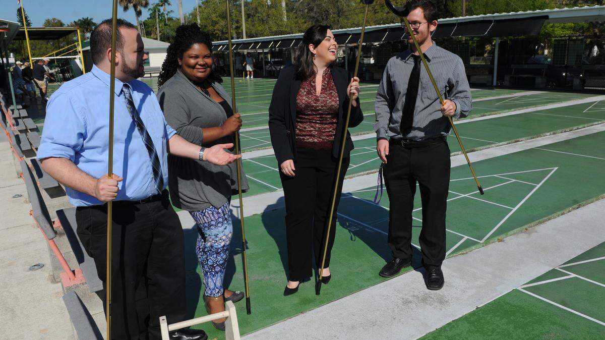 Ogden Clark, Simone Peterson, Anisley Mena and Robert Barto, with the Manatee Millennial Movement, discuss the upcoming #4progress Millennial conference April 1-3. Part of the event will feature a shuffle boarding at the Bradenton Shuffleboard courts. 
 GRANT JEFFERIES/Bradenton Herald