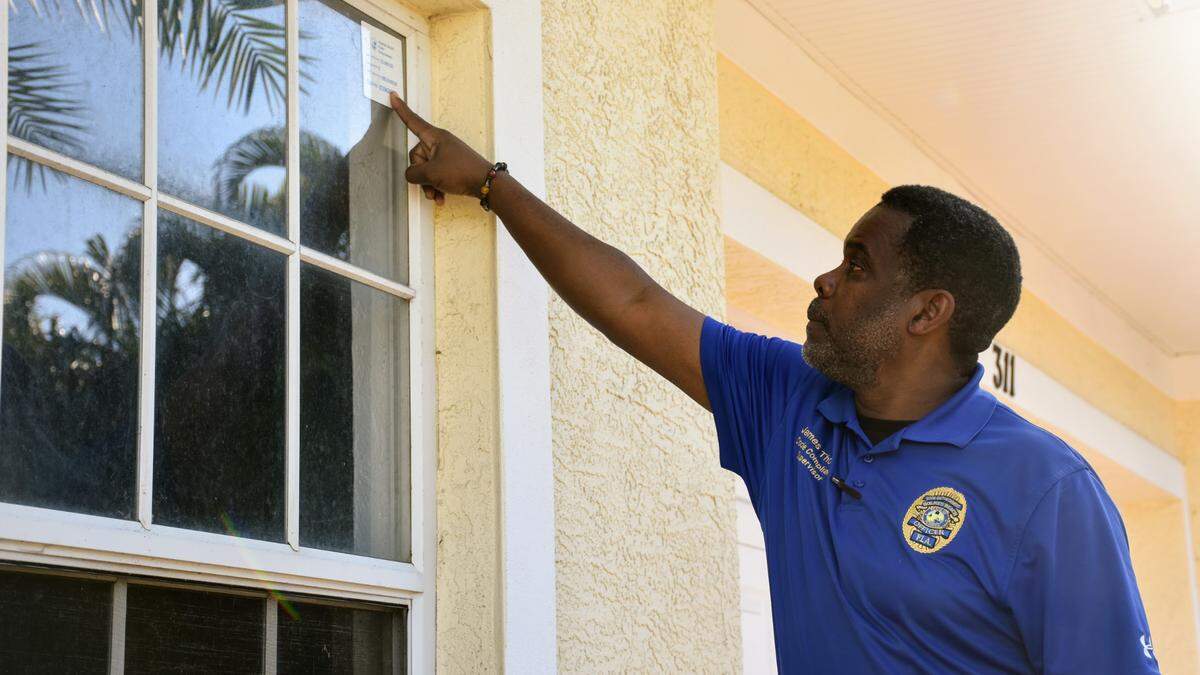 The city of Holmes Beach has used a vacation rental certificate program to regulate short-term rental properties since 2016. On Wednesday, Feb. 2, 2022, Code Compliance Supervisor James Thomas points to a window decal on one rental, which includes the permit number and the unit’s maximum occupancy.