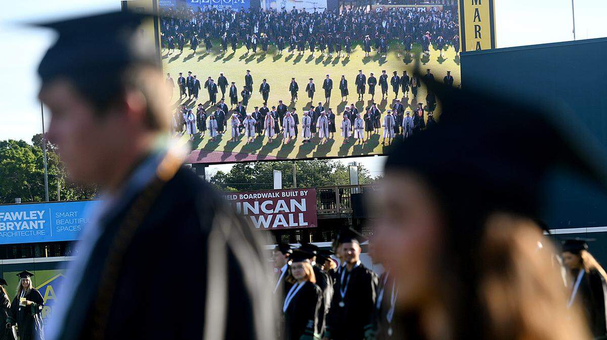 06/03/21—Graduates cross the field as ‘Pomp and Circumstance’ plays at LECOM Park for Lakewood Ranch’s 2021 commencement ceremony.