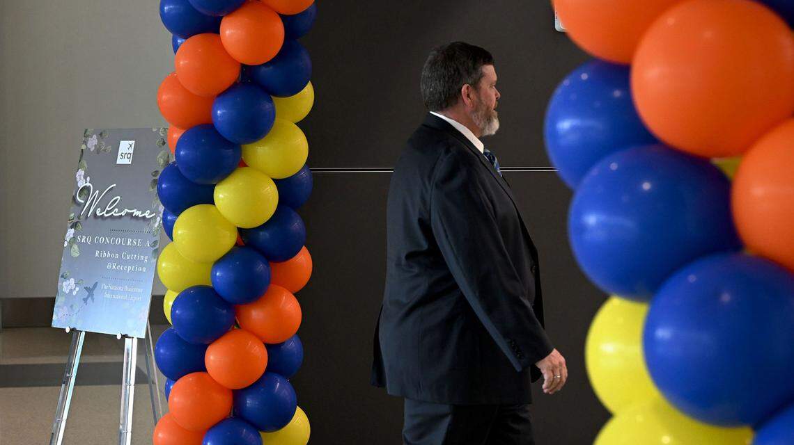 An airport employee arrives through a balloon arch where guests had an opportunity to see Sarasota-Bradenton International Airport’s newest concourse during a VIP event Wednesday. Concourse A has it’s own TSA checkpoint and gates for Allegiant Air.