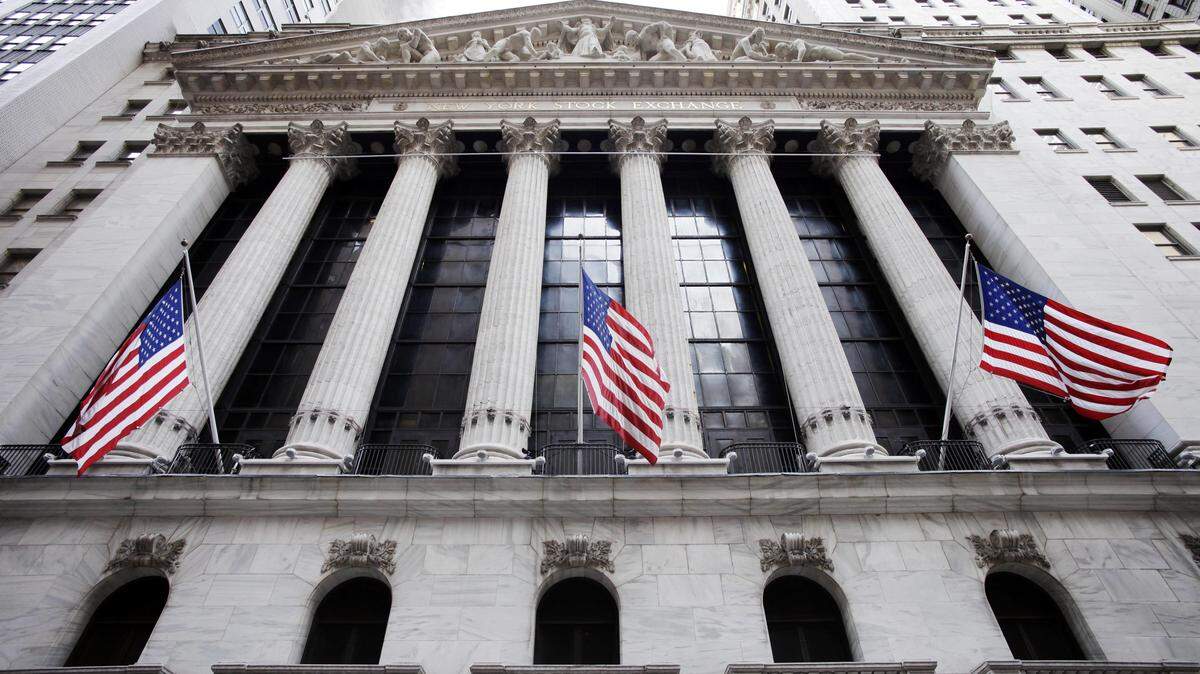 FILE - In this Feb. 10, 2011, file photo, American flags fly in front of the New York Stock Exchange. The price of oil is rising, Wednesday, Feb. 17, 2016, as major oil producing countries are discussing a potential output freeze. (AP Photo/Mark Lennihan, File)