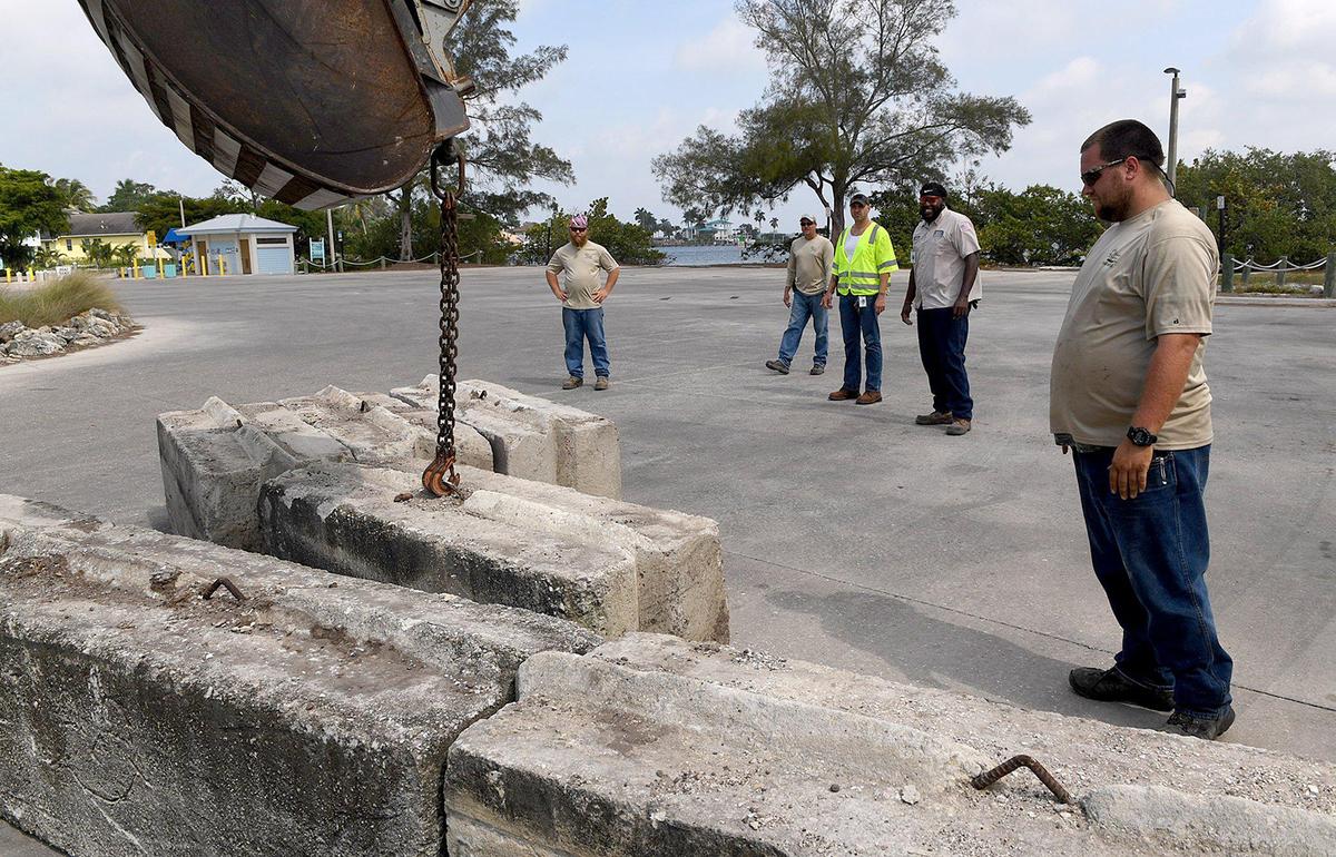 The countyÕs Public Works staff worked throughout the morning to remove concrete barriers, here at Warner’s Bayou, and once again allow access to the boat ramps, which had been closed for two weeks.