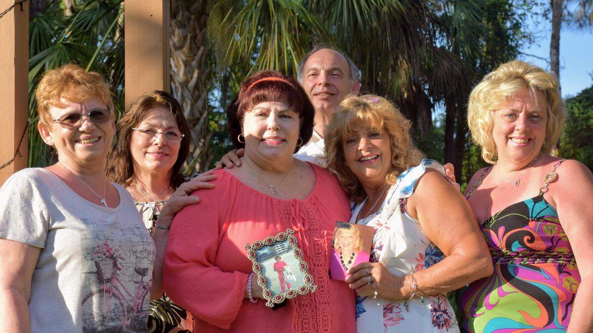 Joanne Lombardi Giordano (middle) poses with her siblings, who she finally met in Bradenton on Mother’s Day Weekend after seeking out the family that put her up for adoption 69 years ago. From left to right: Patricia, who lives in New Hampshire; Joyce, who lives in New York; Joanne, who lives in Lakewood Park, Fla.; Tommy, who lives in Connecticut; Theresa, who lives in Bradenton and Marisa who lives in Rhode Island. Joanne is holding a photo of her late mother, Josephine, Theresa is holding a photo of their late sister, Kathleen.