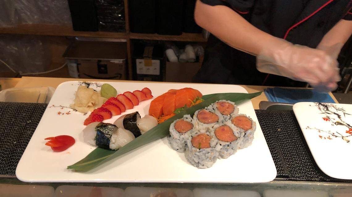 Sushi chef Jason Jong prepares a platter at Yaki Sushi Grill, which recently opened at 5231 University Parkway.