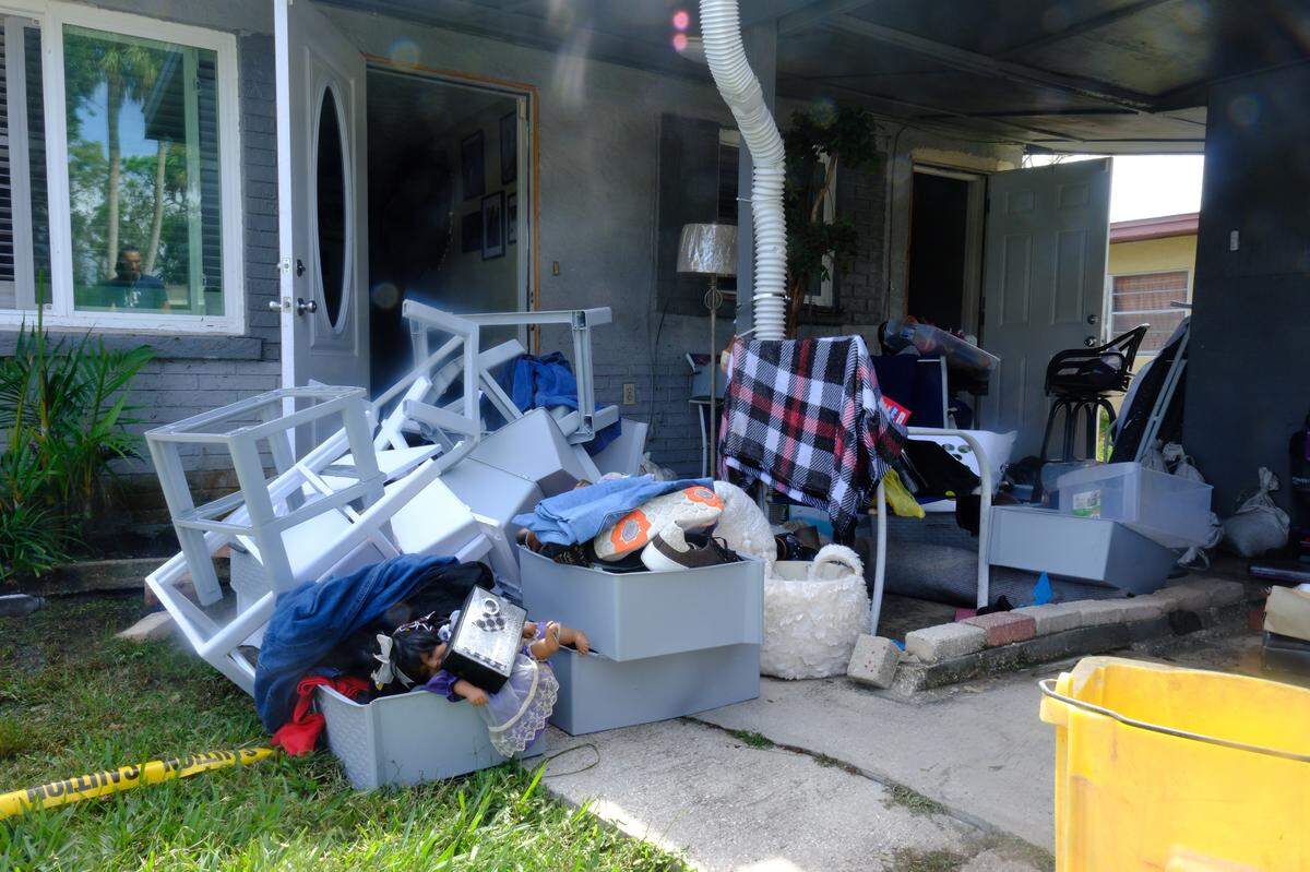 Furniture and other belongings are piled outside of a home in Rubonia after Hurricane Helene brought record storm surge of more than 6 feet to the area.