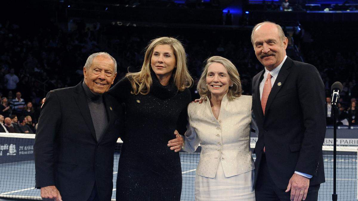 Tennis coach Nick Bollettieri, left, former tennis player Monica Seles, second from left, former head of the U.S. Tennis Association Jan Brown Grimes, and International Tennis Hall of Fame President Stan Smith stand on the court at the BNP Paribas Showdown Tennis Tournament, on Monday, March 3, 2014, in New York. (AP Photo/Kathy Kmonicek)