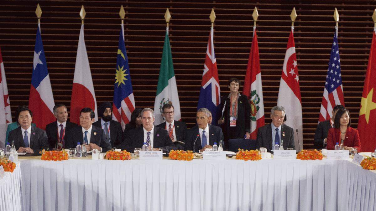 FILE - In this Nov. 10, 2014 file photo, U.S. President Barack Obama, center, speaks during his meeting with leaders of the Trans-Pacific Partnership countries, in Beijing. Sitting with Obama are, from left, Vietnam Minister of Industry and Trade Vu Hoy Hoang, Vietnam Prime Minister Nguyen Tan Dung, U.S. Trade Representative Ambassador Mike Froman, Singapore Prime Minister Lee Hsien Loong, and Singapore Sec. of Ministry of Trade and Industry Ow Foong Pheng. The United States and 11 other Pacific Rim countries on Monday, Oct. 5, 2015, agreed to the Trans-Pacific Partnership, an ambitious and controversial trade pact that cuts trade barriers, sets labor and environmental standards and protects multinational corporations' intellectual property. (AP Photo/Pablo Martinez Monsivais, File)