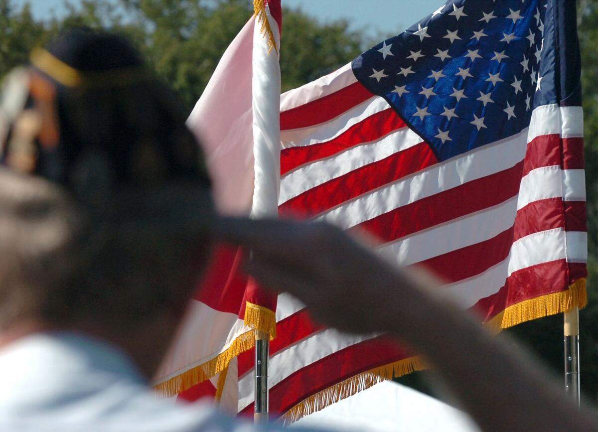A veteran salutes as the American flag passes before him, at the Veterans Day ceremony in Palmetto. Veterans Day observances in Manatee County are planned primarily for Monday, Nov. 11.