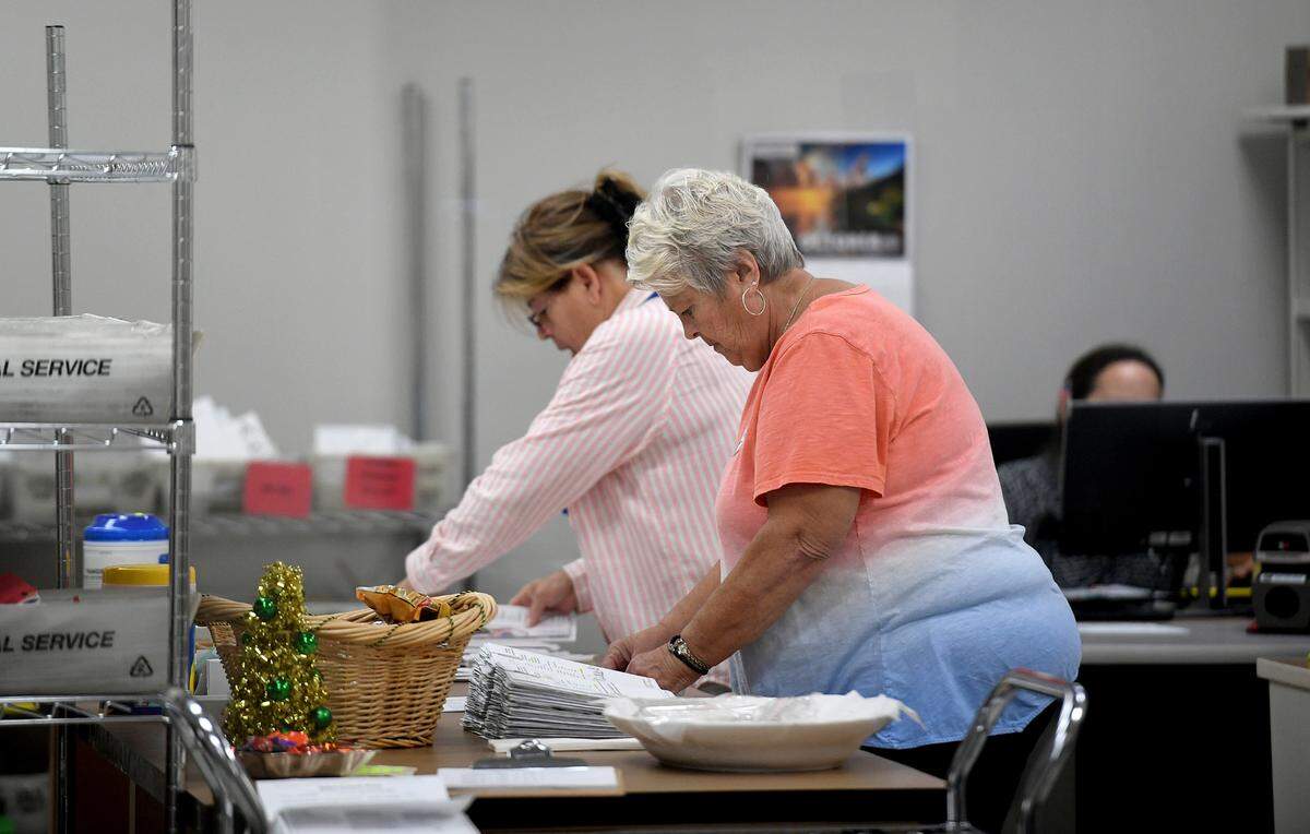 Workers at the Manatee County Supervisor of Elections sort mail in ballots in preparation for counting on Nov. 8, 2022.