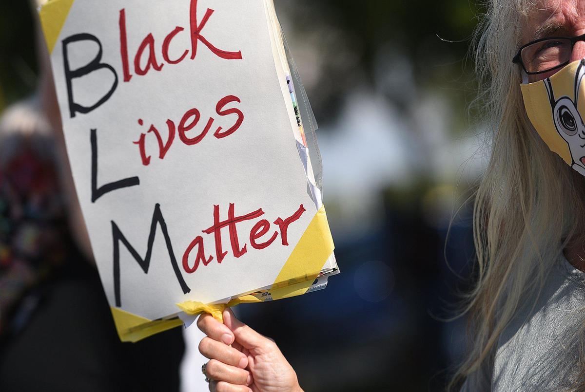 A protester holds up a sign during Black Lives Matter protest in Sarasota to highlight case of Ronald Davenport, who was charged with resisting without violence during a traffic stop on May 12, 2020.