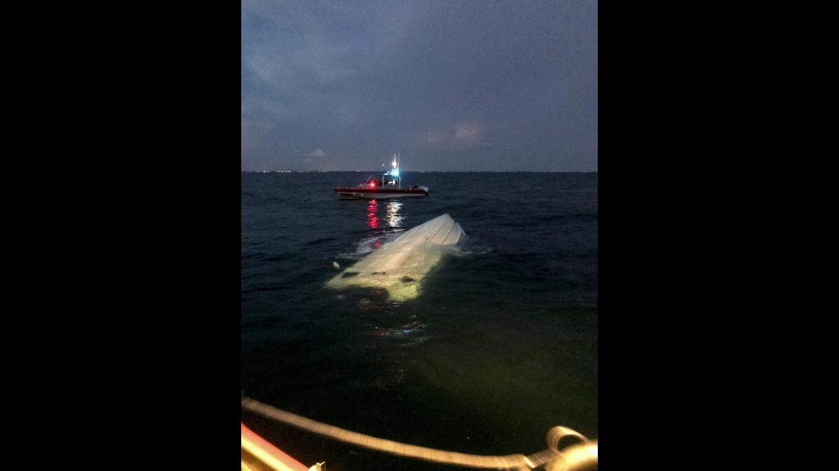 U.S. Coast Guard crews rescued two boaters after their vessel capsized Thursday near Longboat Key.