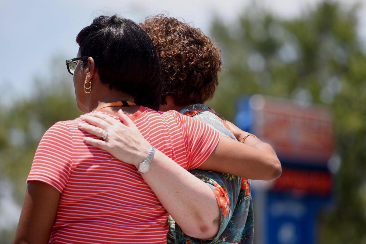 Southeast High principal Rosa Faison and teacher Cheri Greenhalgh are emotional as they talk about two grads who died in an accident in Peru.