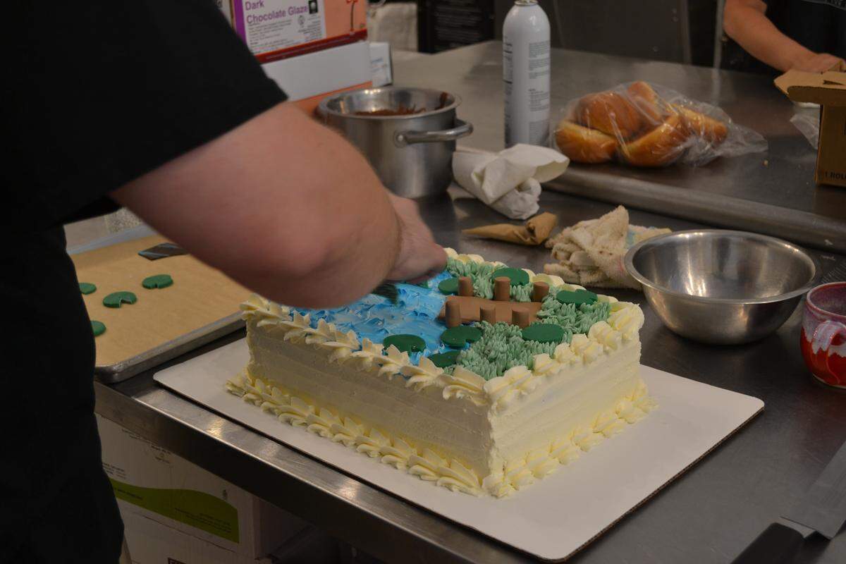 A cake halfway through decoration at Sugar Cubed Pastry Lab in downtown Bradenton.